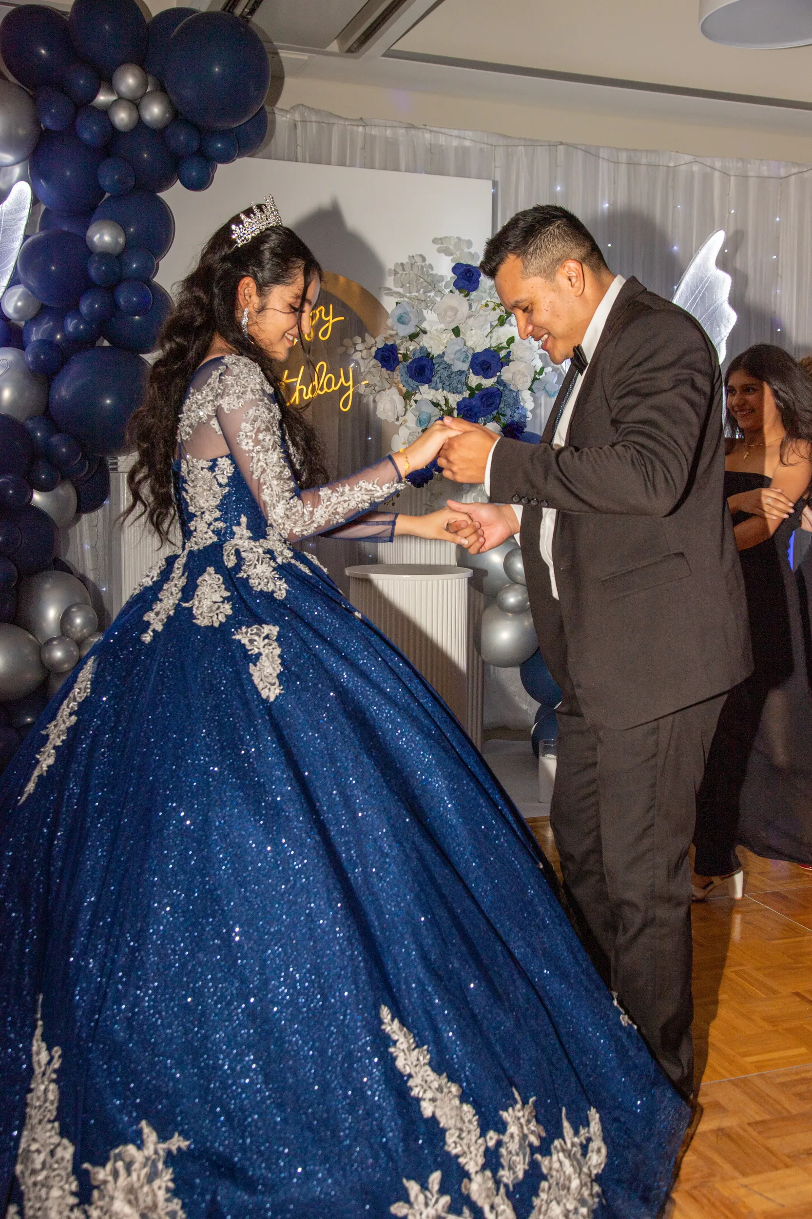 Special father-daughter dance moment at debut with blue ball gown and balloon decorations