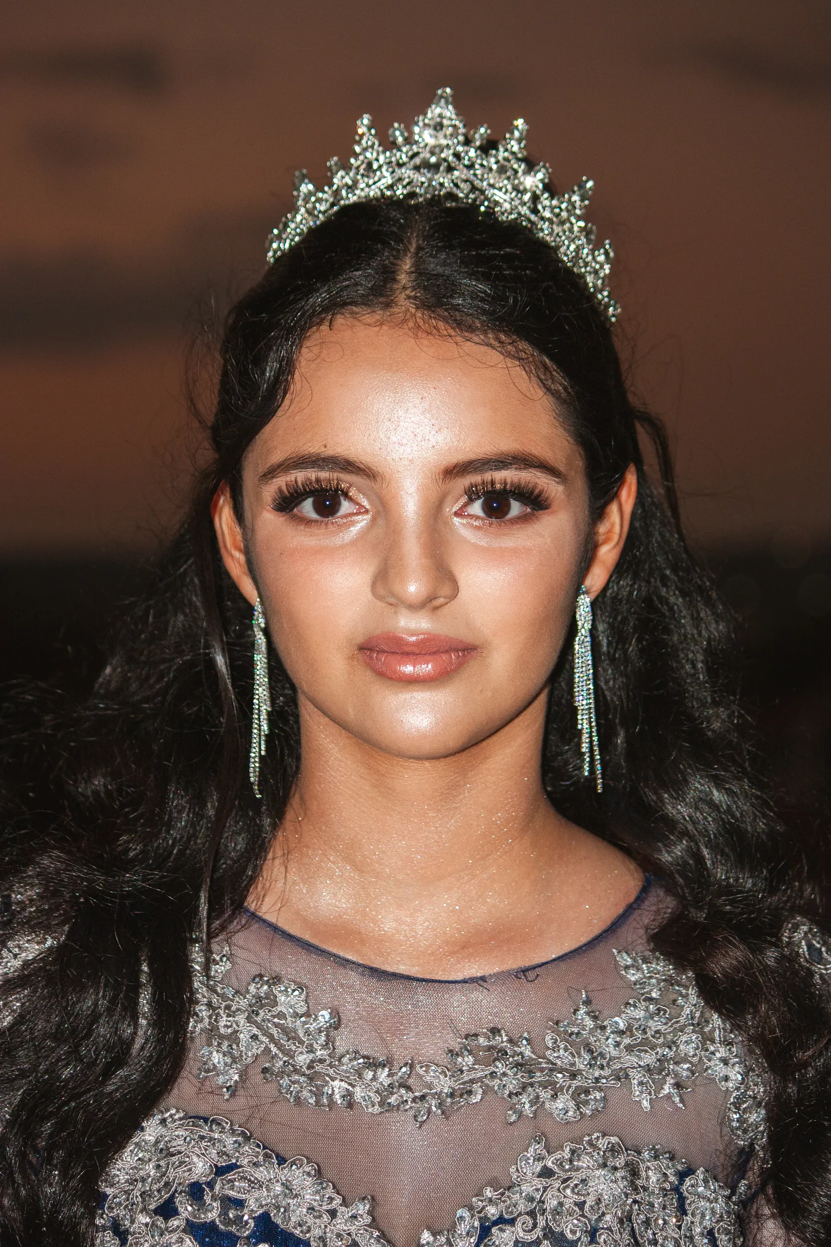 Stunning debut portrait featuring ornate crystal tiara and matching earrings with blue embellished gown