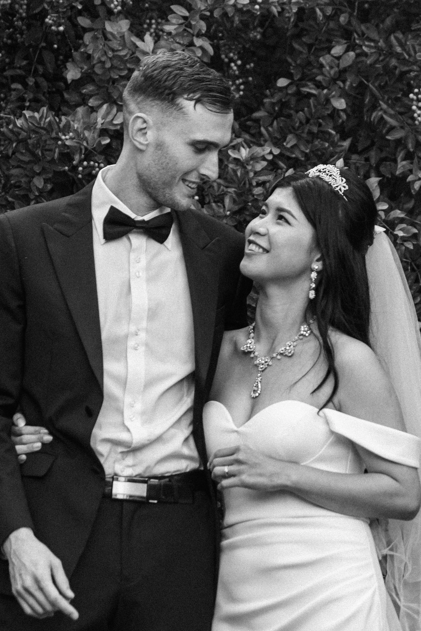 Beautiful black and white intimate portrait of Huiyu and Chris with bride wearing crystal tiara and statement necklace